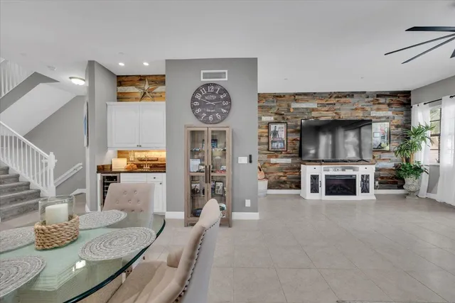 a living room with furniture and a ceiling fan