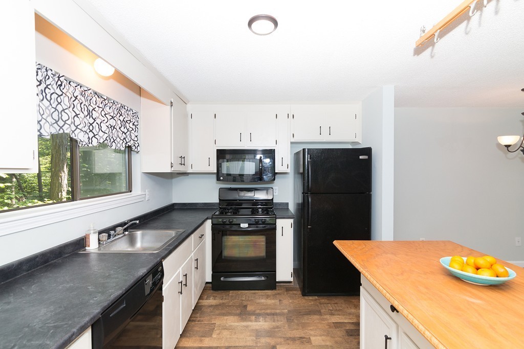 39 Mountain Gate Road, Unit 39 Ashland, MA 01721 - Photo 1 of 30 a kitchen with stainless steel appliances granite countertop a refrigerator a stove and a sink