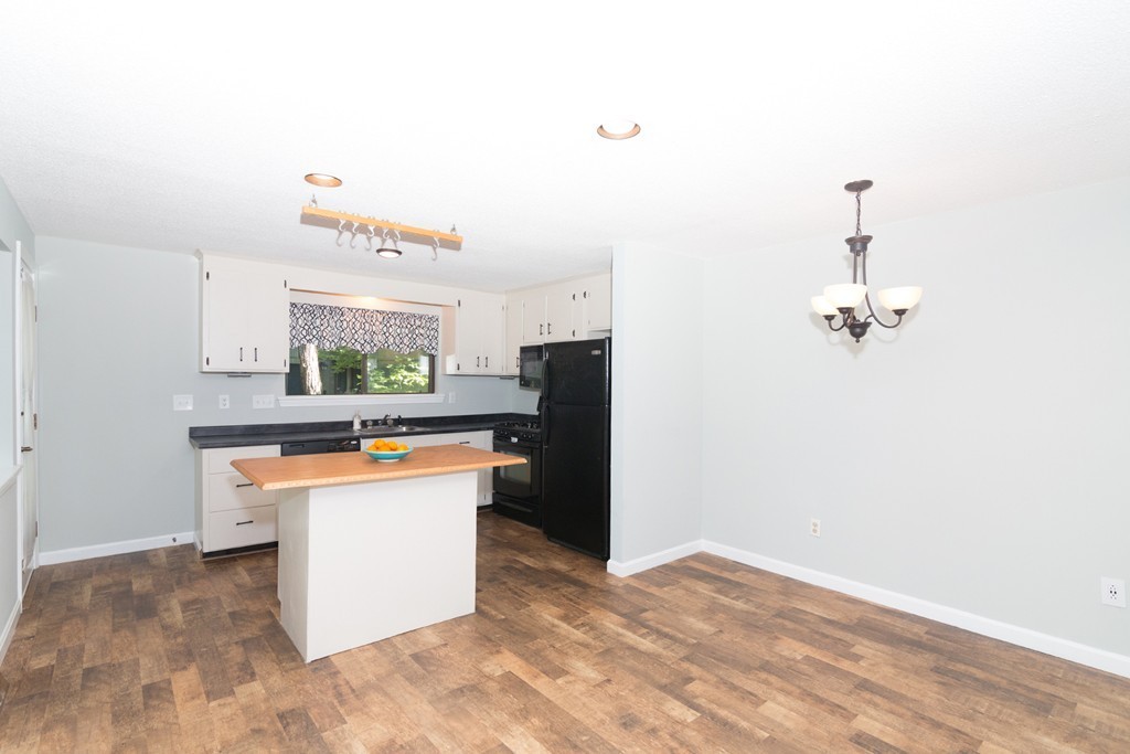 39 Mountain Gate Road, Unit 39 Ashland, MA 01721 - Photo 7 of 30 a kitchen with granite countertop a refrigerator a sink and dishwasher