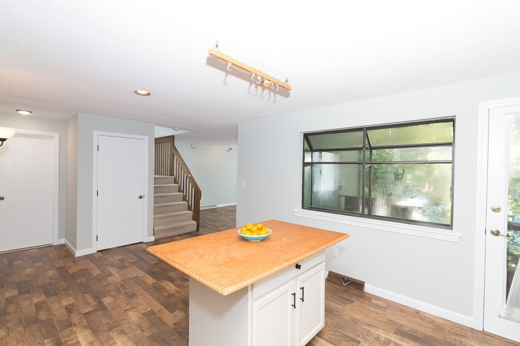 39 Mountain Gate Road, Unit 39 Ashland, MA 01721 - Photo 8 of 30 a kitchen that has a lot of cabinets and wooden floor