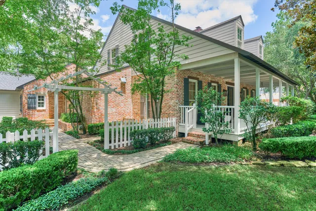 a front view of a house with a garden and plants