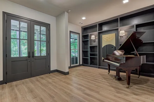 a room with wooden floor and furniture