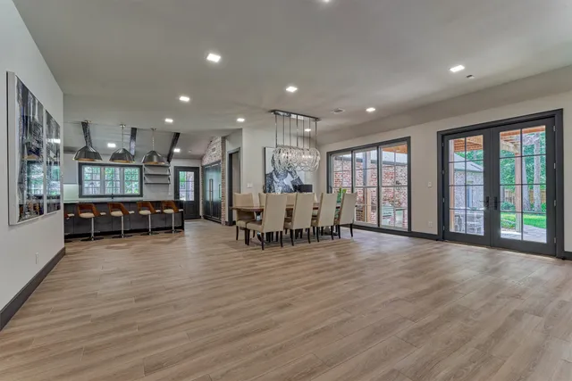 a room with lots of furniture and large windows