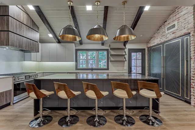 a kitchen with a table chairs and wooden floors
