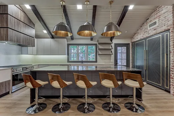 a kitchen with a table chairs and wooden floors