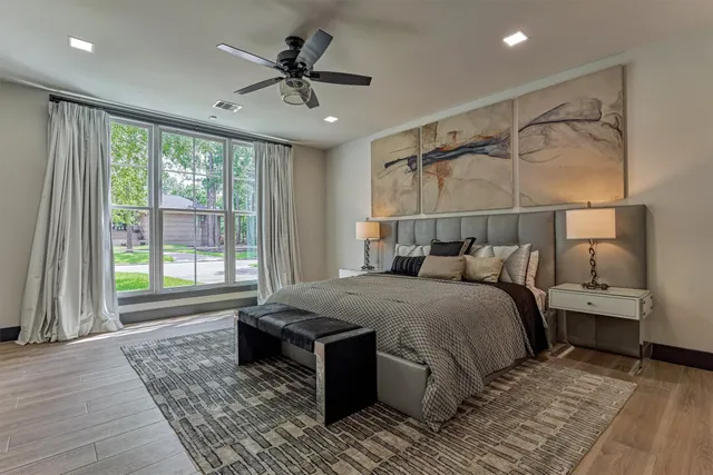 a bedroom with a large bed and a window