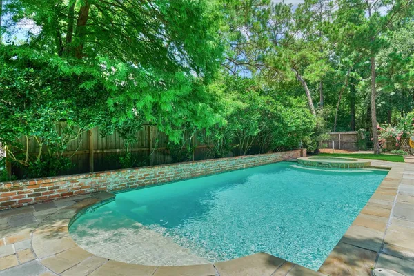 a view of a house with backyard sitting area and garden