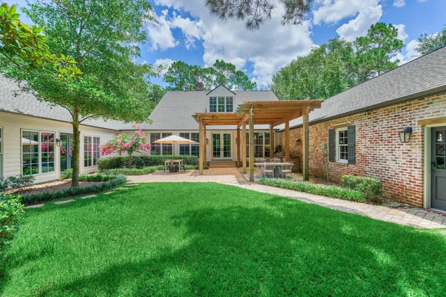 a patio with a table and chairs under an umbrella