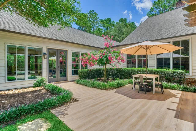 a view of a house with backyard sitting area and garden