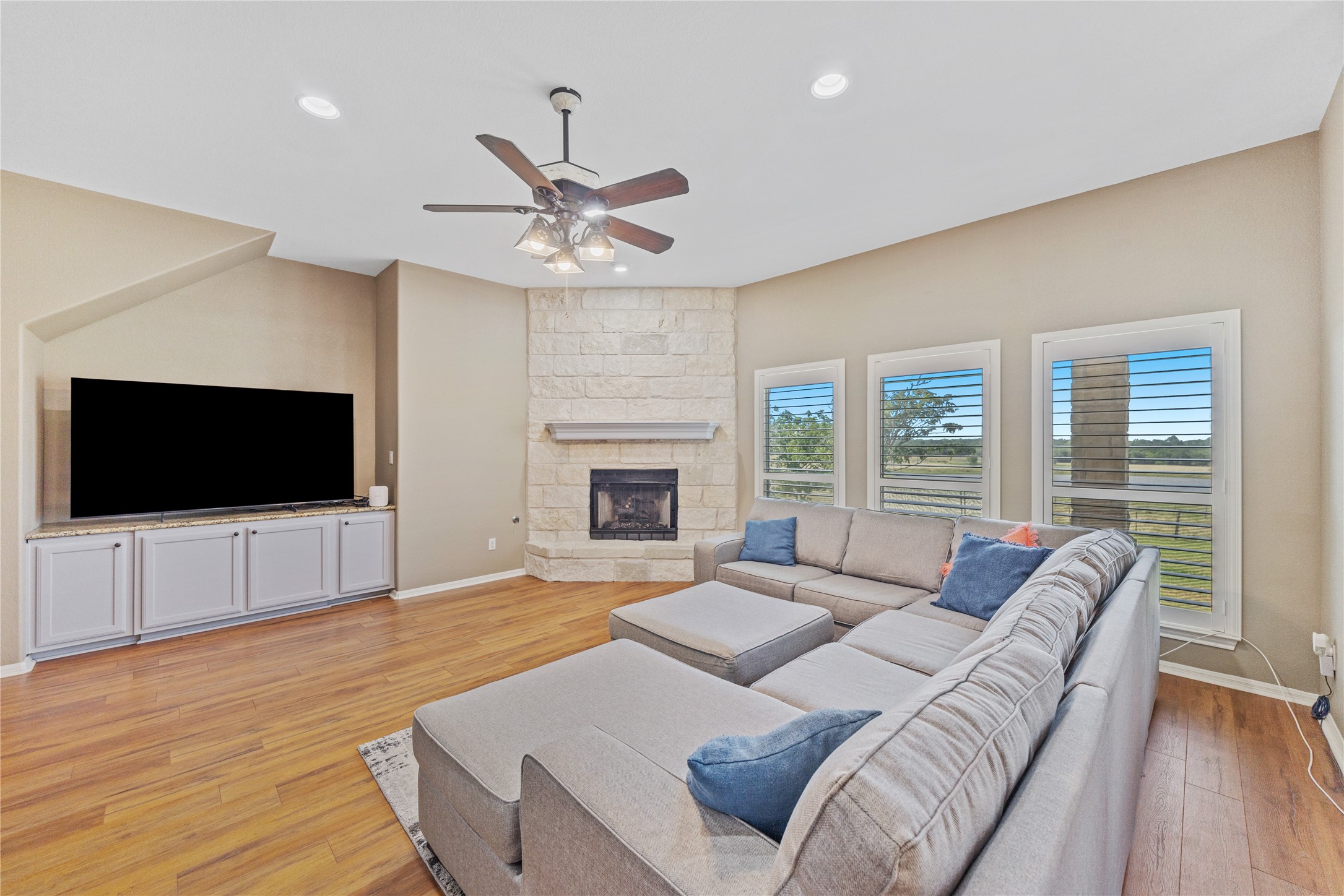 20145 Janak Road Coupland, TX 78615 - Photo 7 of 40 A corner fireplace and ample built-in cabinetry define this inviting living space.