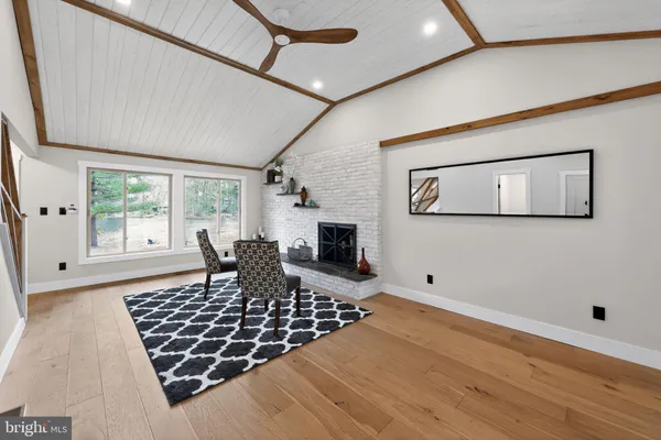 a living room with furniture rug and a window