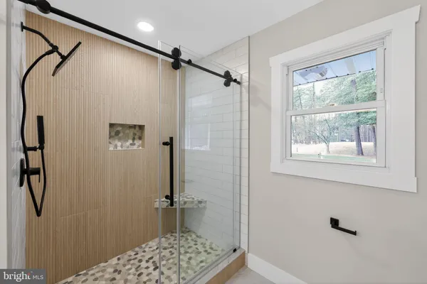 a bathroom with a shower and a window