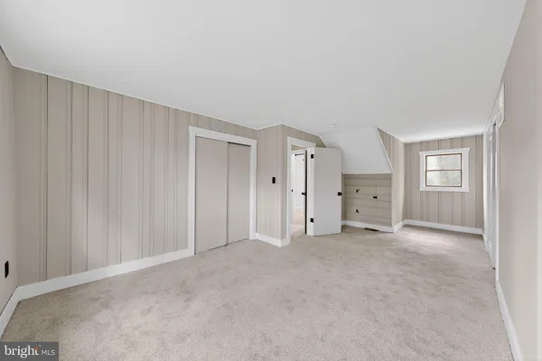 a view of an empty room and closet area