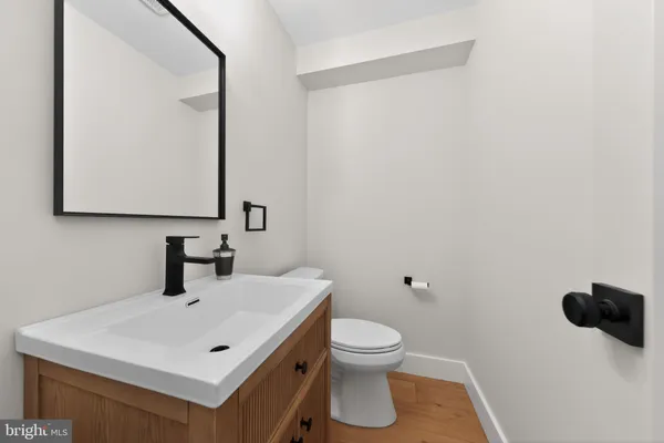 a bathroom with a sink a toilet and mirror