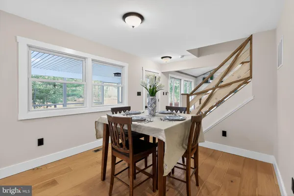 a view of a dining room with furniture and a potted plant