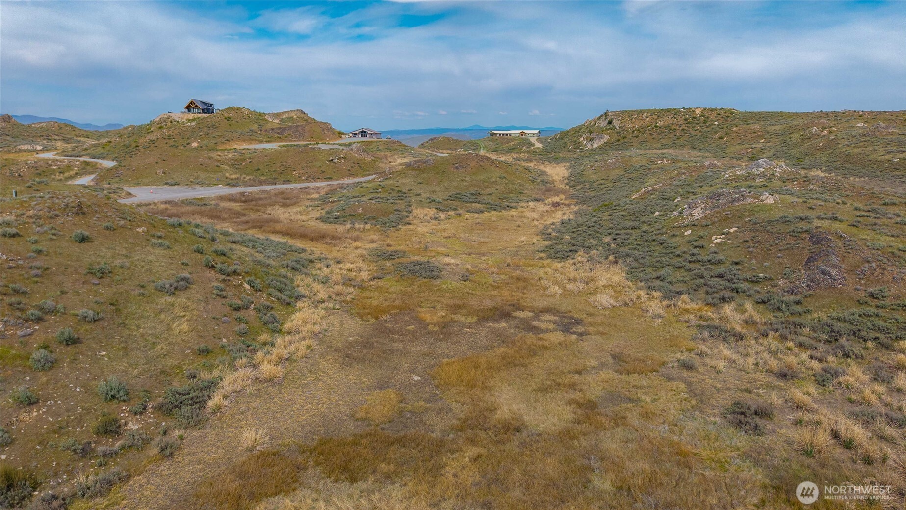 1-azteca Plata Road Brewster, WA 98812 - Photo 15 of 40 a view of a mountain range with a lush green hillside