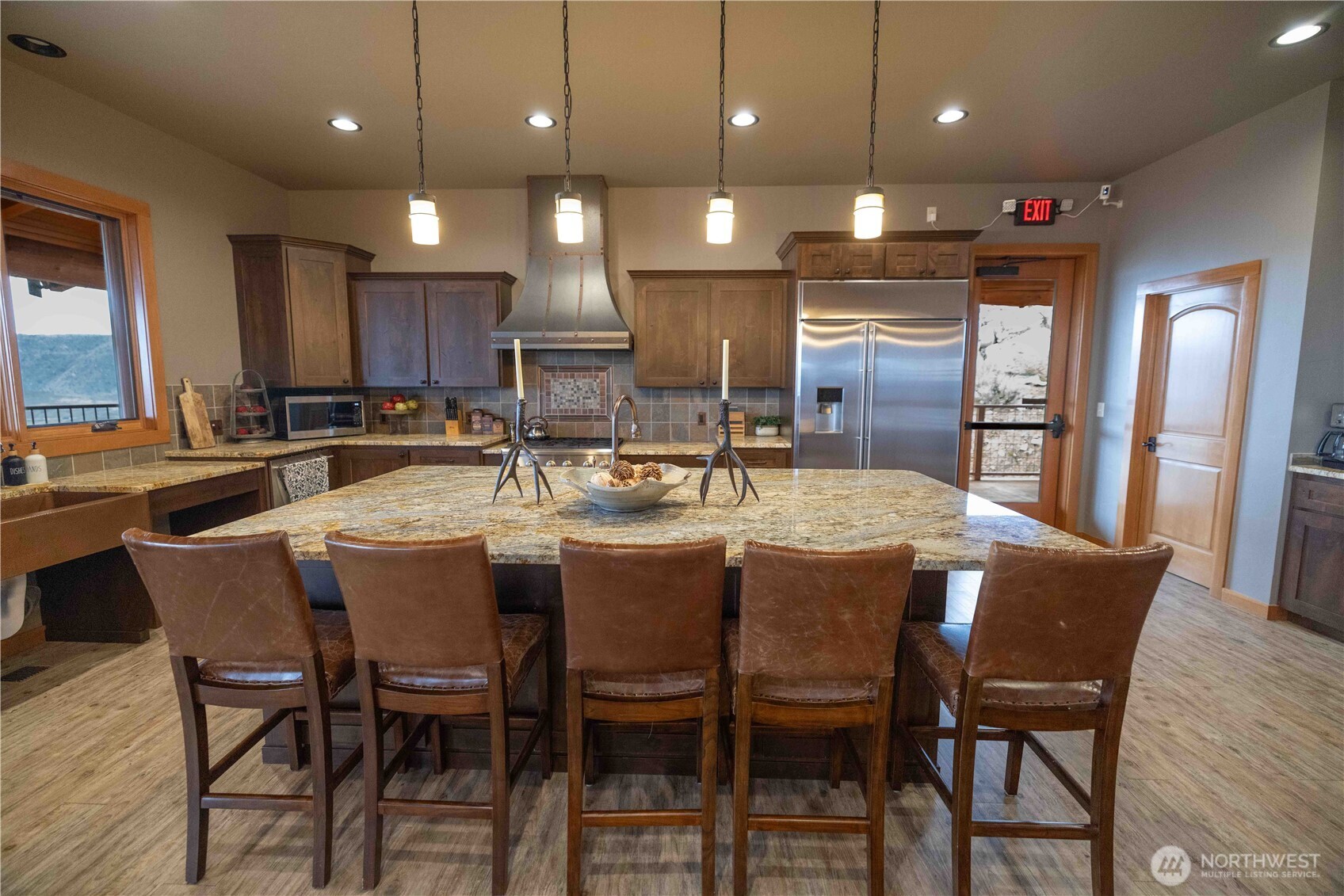 1-azteca Plata Road Brewster, WA 98812 - Photo 30 of 40 a kitchen with a dining table chairs stainless steel appliances and cabinets
