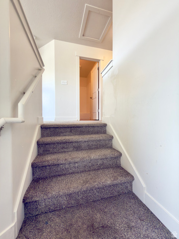 1823 South Longview Road Santaquin, UT 84655 - Photo 29 of 69 Carpeted staircase with white trim, leading to an upper landing