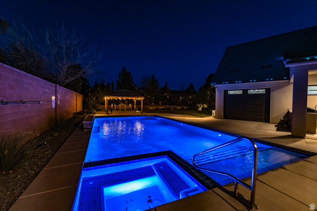 1283 North Gallen Road Santa Clara, UT 84765 - Photo 4 of 103 Pool at night with an in-ground hot tub, a gazebo, a patio area, and an outdoor pool