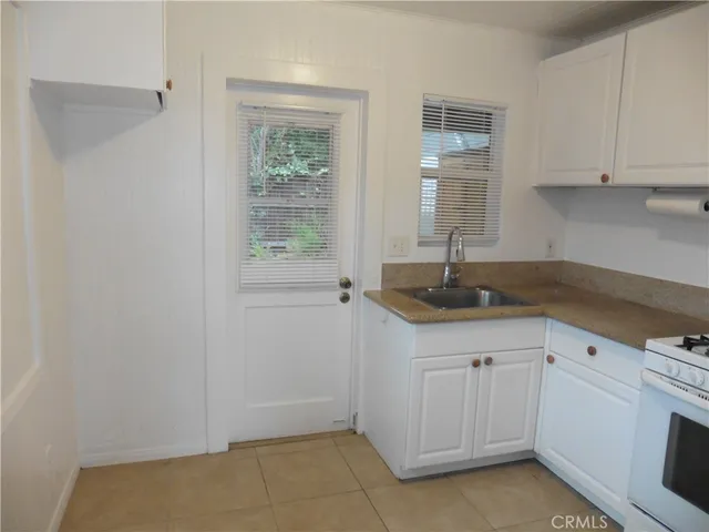 a kitchen with a sink cabinets and window