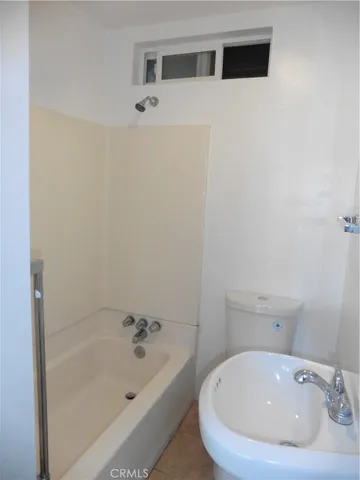 a bathroom with a bathtub and sink