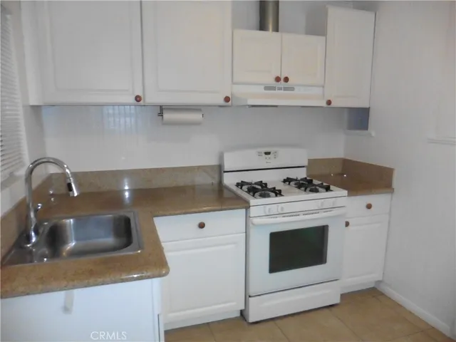 a kitchen with a stove and a sink