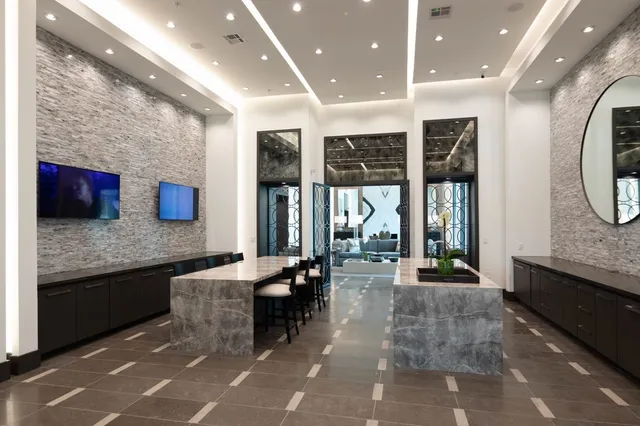 a lobby with furniture and floor to ceiling window