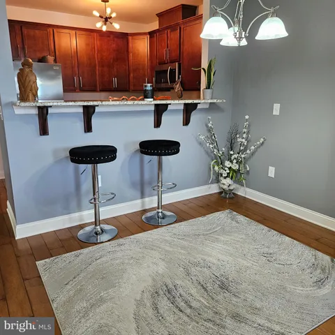a view of kitchen with furniture and a chandelier