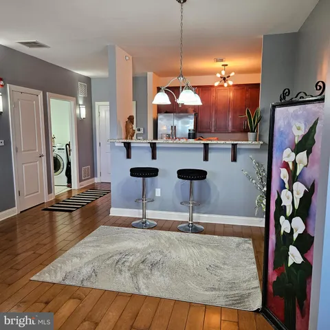 a view of a living room with furniture and a floor to ceiling window