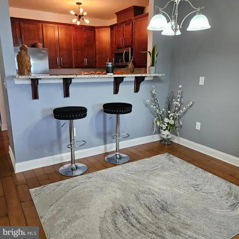 a view of kitchen with furniture and chandelier