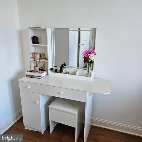 a bathroom with a sink vanity and mirror