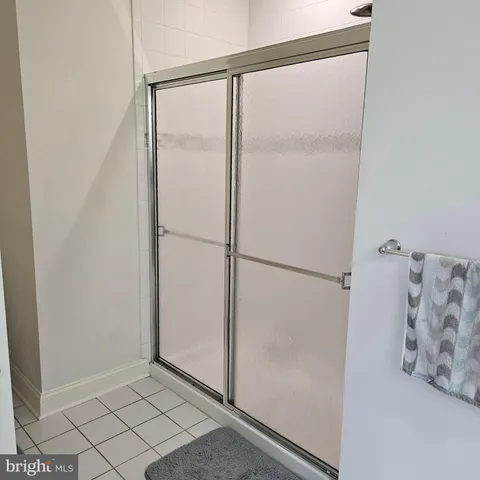 a bathroom with a glass shower door