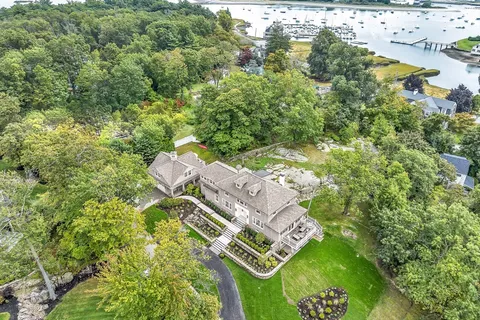 an aerial view of a residential houses with yard