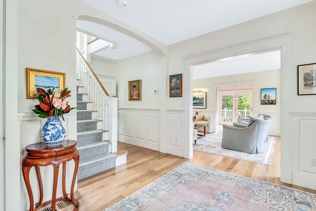 a living room with furniture a wooden floor and a potted plant