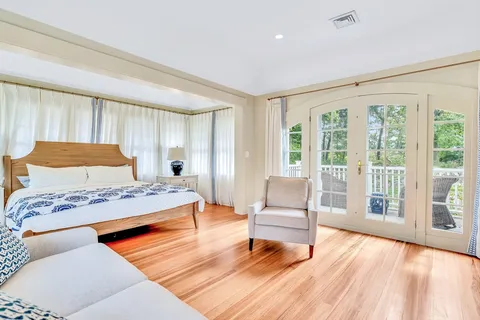 a bedroom with a bed and a large window