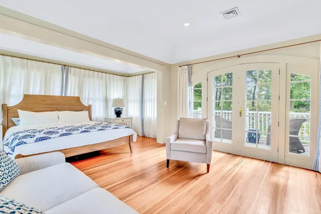 a bedroom with a bed and a large window