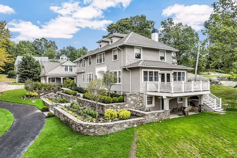 a aerial view of a house with a yard table and chairs