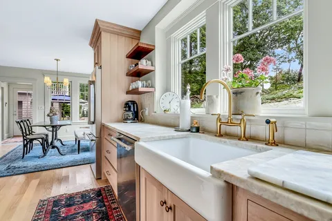 a kitchen with stainless steel appliances granite countertop a sink and a refrigerator