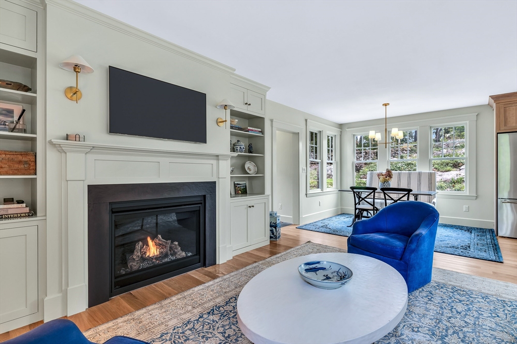 17 Atlantic Avenue, Unit MAIN HOUSE Cohasset, MA 02025 - Photo 7 of 22 a living room with furniture a flat screen tv and a fireplace