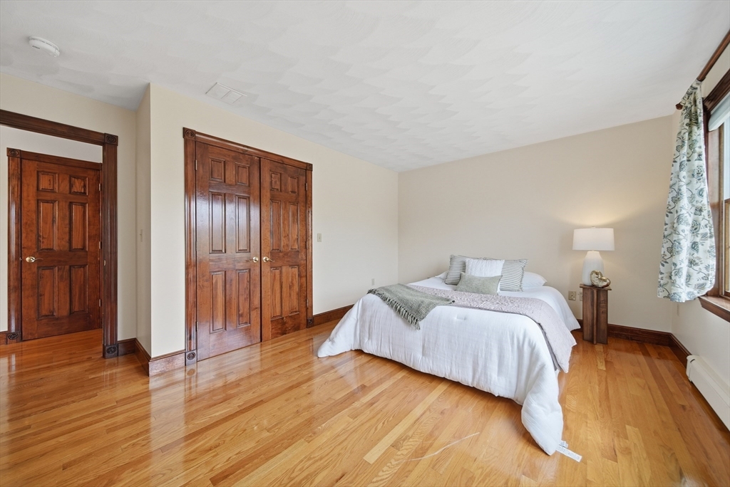 131 Range Heights Road Lynn, MA 01904 - Photo 11 of 36 a bedroom with a bed and wooden floor