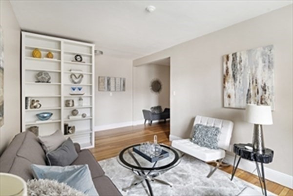 a living room with furniture and a lamp