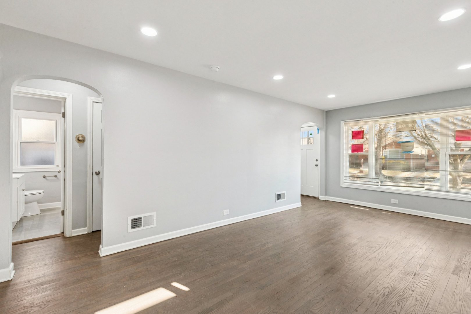 14230 South Normal Avenue Riverdale, IL 60827 - Photo 11 of 33 an empty room with wooden floor and window