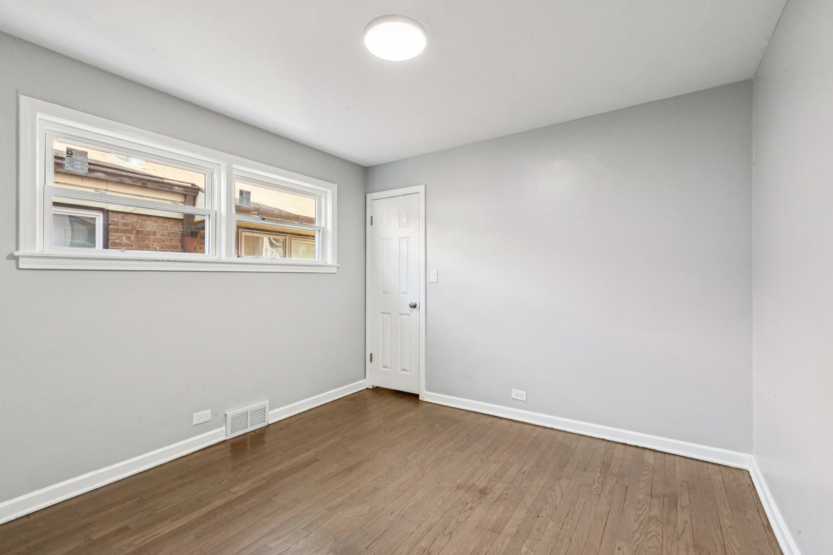 14230 South Normal Avenue Riverdale, IL 60827 - Photo 20 of 33 a view of an empty room with wooden floor and a window