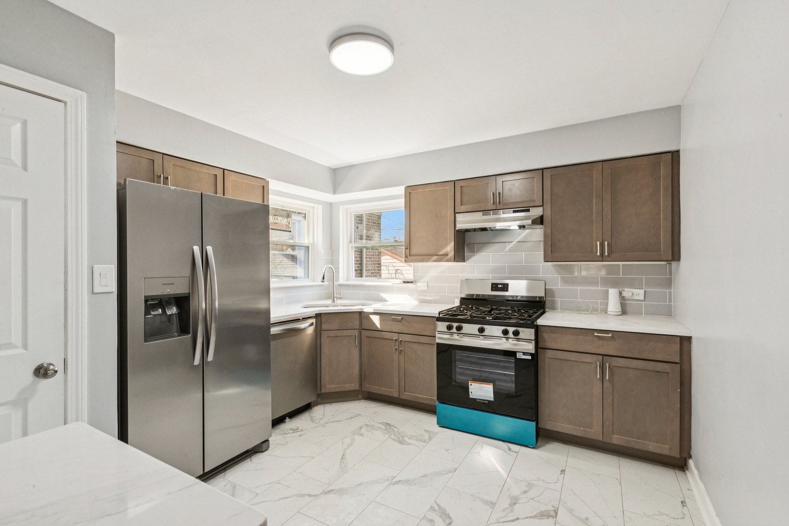 14230 South Normal Avenue Riverdale, IL 60827 - Photo 5 of 33 a kitchen with stainless steel appliances granite countertop a stove a refrigerator and a sink