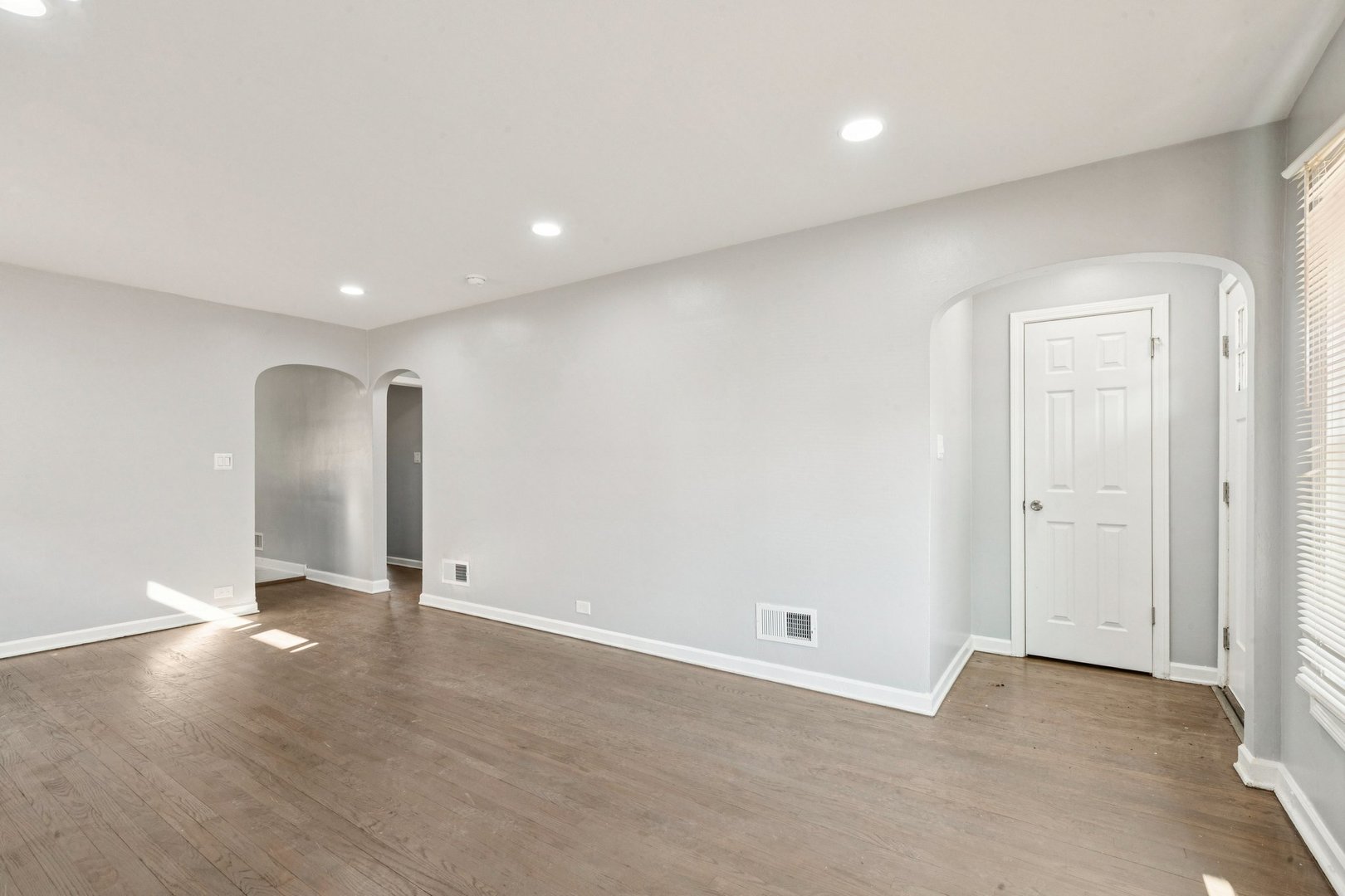 14230 South Normal Avenue Riverdale, IL 60827 - Photo 9 of 33 an empty room with wooden floor and windows