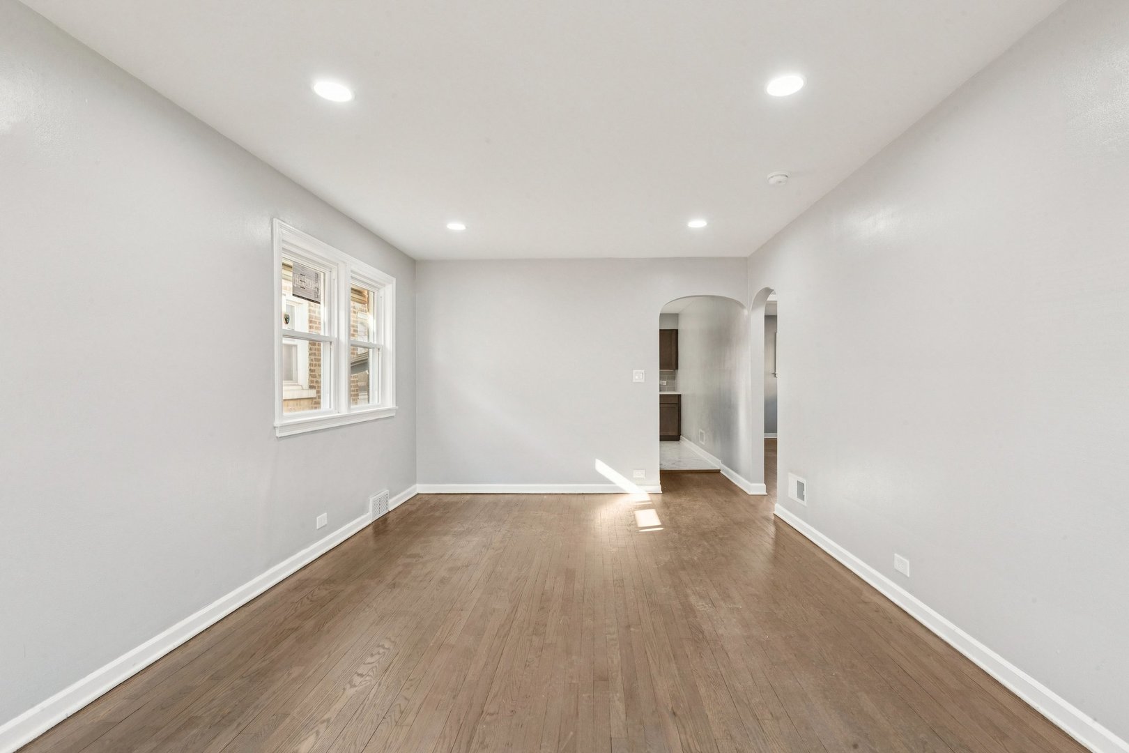 14230 South Normal Avenue Riverdale, IL 60827 - Photo 10 of 33 an empty room with wooden floor and windows