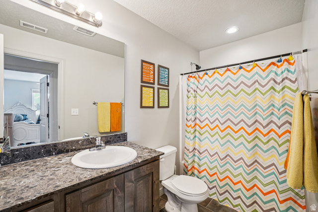 203 North 1900th Street West Mapleton, UT 84664 - Photo 22 of 48 Full bathroom featuring a single vanity with a white oval sink, dark wood-finish cabinetry, and a stone-finish countertop
