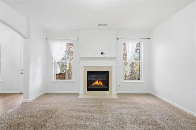 a living room with a fireplace and a window
