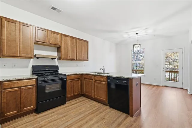 a kitchen with stainless steel appliances granite countertop a stove and a sink