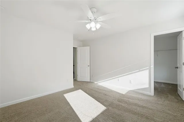an empty room with fan and entrance